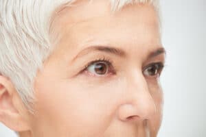 Close up of senior woman eyes. Gray short hear.