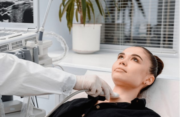 diagnostic center making ultrasound thyroid gland test.