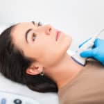 Woman patient receives thyroid diagnostics.