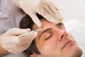 Man receiving Botox injection for wrinkle reduction and facial rejuvenation