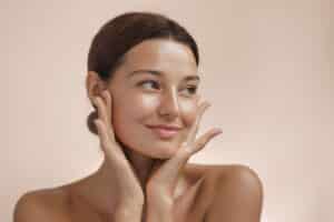 Woman showing smooth facial skin after Xeomin treatment.